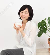 Young asian woman relax with a cup