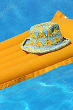 Hat on orange airbed