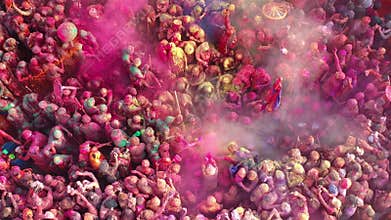Aerial footage of people celebrating the holi color festival at Nandgaon Temple, Uttar Pradesh, India.