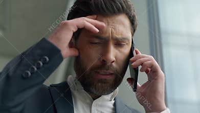 Close up unhappy frustrated Caucasian middle-aged business man talking mobile phone call failure upset in office worry