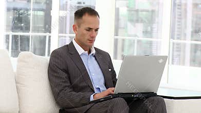 Handsome business man working at a laptop