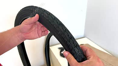 Mechanic showing a new bicycle tire