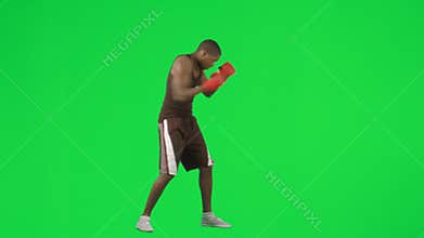 Young ethnic man boxing against green screen footage