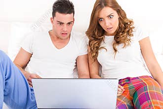 Shocked couple in love watching horor movie