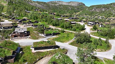Houses with Green Grassed Roof. Ancient building tradition of Grass Growing on the Roof of Houses in Norway. Aerial.