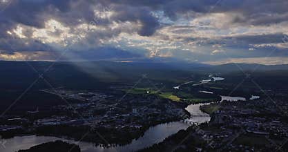 Drone cityscape view of Drammen in Norway with crooked river through the city at sunset with sunrays