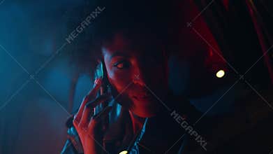 African lady chatting cellphone sitting taxi backseat closeup. Smiling woman
