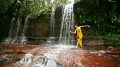 dancer on waterfall in borneo rainforest