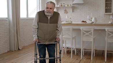 Senior grey haired man with age-related impairment walking using walker