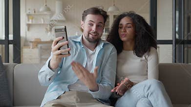 Expressive Woman Sharing Story On Video Call While Man Listens With Amused Look