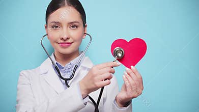 Female doctor cardiologist showing heart symbol