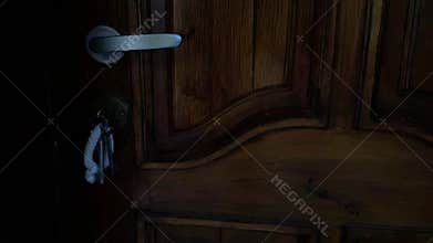 Police blue and red flashing lights at the scene of a burglary, wooden door with a key in the lock