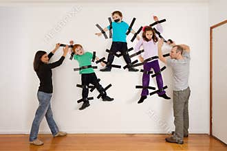 Parents sticking children to wall joke