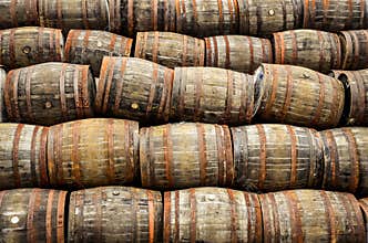 Stacked pile of old whisky and wine wooden barrels