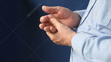 Man massages his left hand