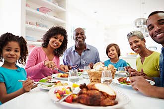 Multi Generation African American Family Eating Meal At Home