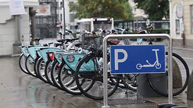 Static shot of a parking for bikes and electric scooters on a roadside in the city