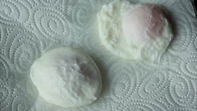 preparing delicious poached egg closeup