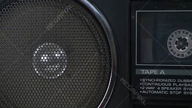 Vintage boombox playing a cassette tape