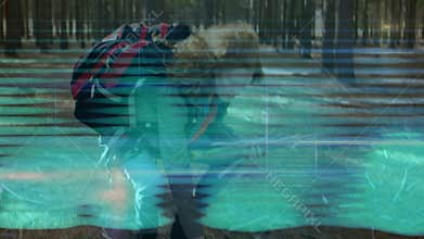 woman hiker crouching in pine forest, health app displaying glitch scan-line animated overlays