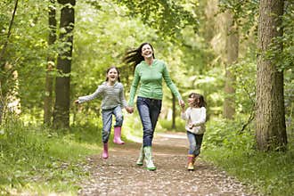 Family Running Through Woods
