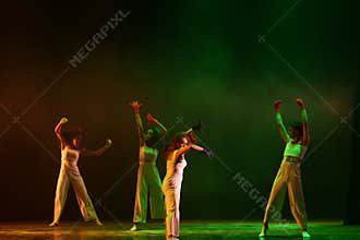Modern Contemporary Dance Performance Under Green Stage Illumination