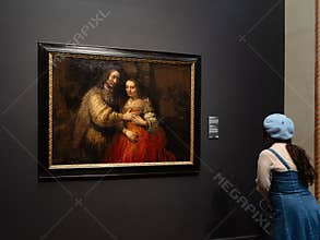 Visitor Viewing Rembrandt Painting at Rijksmuseum Amsterdam