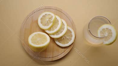 Making lemonade with fresh lemons on a yellow table