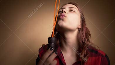 Beautiful girl blowing soap bubbles