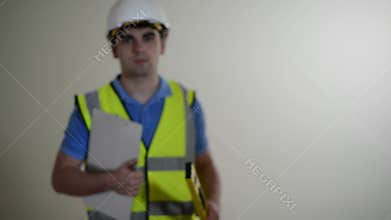 Builder Wearing Safety Helmet Walks Into Focus And Smiles