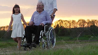 Disabled Grandfather is Driven In a Wheelchair