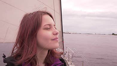 Young girl on a boat enjoys fresh sea air 4K UHD slowmo