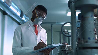 Scientist in mask writing in lab