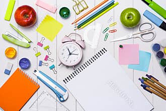 School stationery or office supplies on wood background.