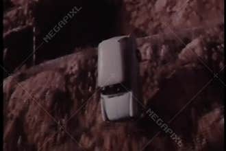 Slow motion car falling off cliff into water