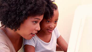 Child with her mother in the computer
