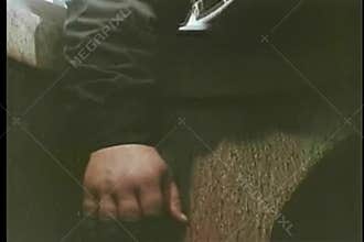 Close-up of hand blindly activating bomb hidden in manhole