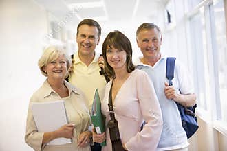 A group of adult students standing in a corridor
