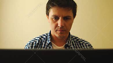 Portrait of man carefully working on a notebook