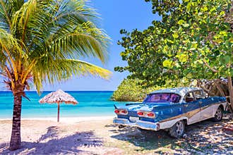 Vintage american oldtimer car on a beach in Cuba