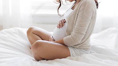 Happy pregnant woman touching her tummy at home 31