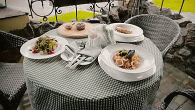 Table with dishes in a cafe on the street