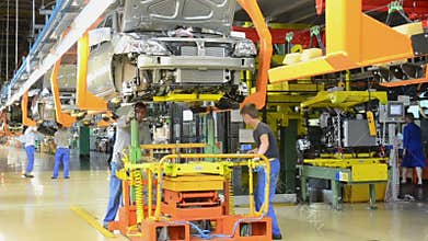 People work at assembly of cars Lada Kalina on conveyor of factory AutoVAZ