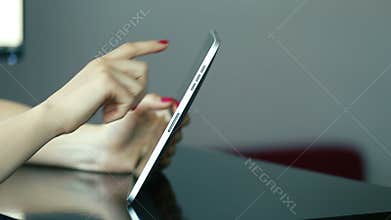 Close up of woman hands using tablet computer indoor