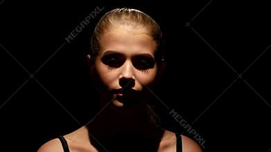 Portrait of a beautiful girl. Makeup. Black. Closeup