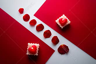 Heart candle on the red cartons, and rose petals in between