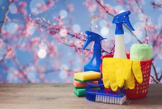 Spring cleaning concept with supplies over floral background