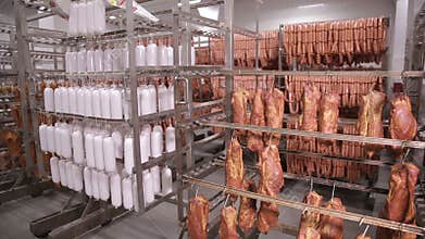 Dried meat, sausages, meat products hanging in the food factory storage.