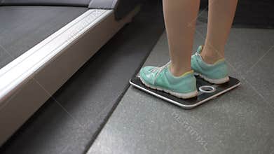 Woman happy after checking her weight