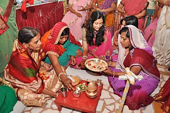 Women wearing traditional indian outfits during wedding rituals